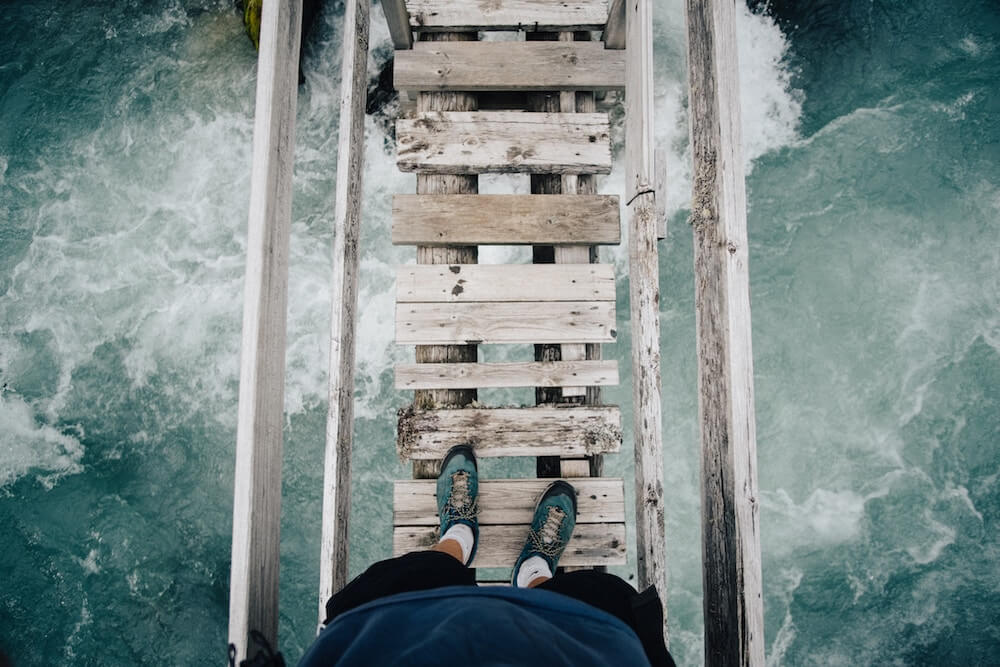 financial mistakes can be scary like crossing a rickety bridge